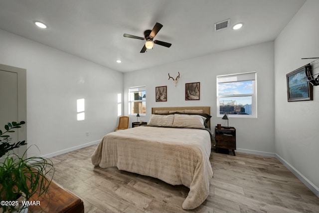 bedroom featuring recessed lighting, visible vents, light wood-style floors, a ceiling fan, and baseboards