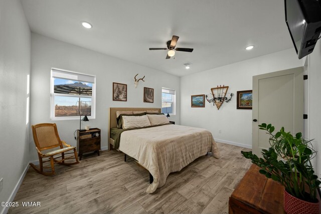 bedroom with a ceiling fan, recessed lighting, light wood-style flooring, and baseboards