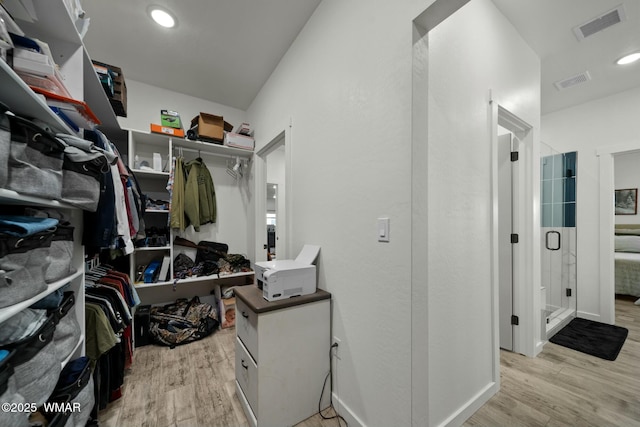 walk in closet with light wood-type flooring and visible vents