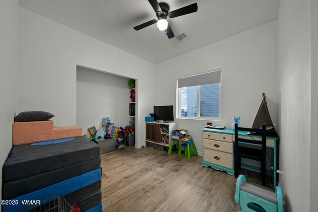 interior space with light wood-type flooring, ceiling fan, and visible vents