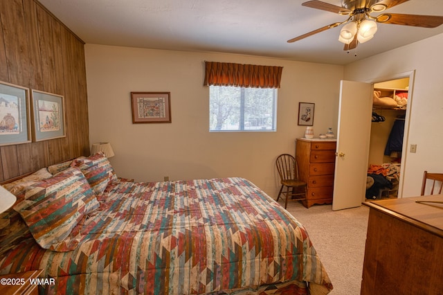 4300 W Burke, Show Low, AZ 85901 - bedroom featuring light carpet, a ceiling fan, a spacious closet, and wood walls