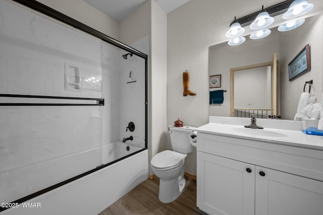 451 S Spirea Ln, Show Low, AZ 85901 - full bath featuring toilet, wood finished floors, vanity, enclosed tub / shower combo, and a textured wall