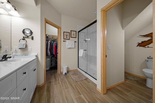 451 S Spirea Ln, Show Low, AZ 85901 - bathroom with toilet, wood finished floors, a shower stall, and vanity