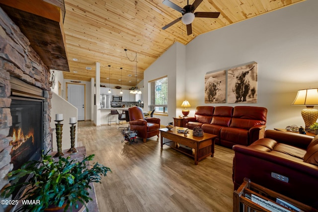 451 S Spirea Ln, Show Low, AZ 85901 - living room with wooden ceiling, ceiling fan, a stone fireplace, light wood finished floors, and high vaulted ceiling