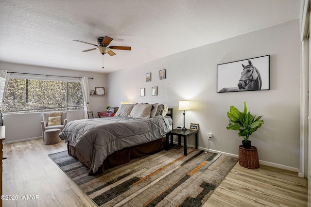 2670 Snow Slope Way, Pinetop, AZ 85935 - bedroom featuring wood finished floors, baseboards, ceiling fan, and a textured ceiling