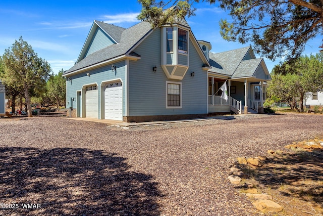 6853 Rim Rock Rd, Show Low, AZ 85901 - view of property exterior featuring a porch, a shingled roof, and an attached garage