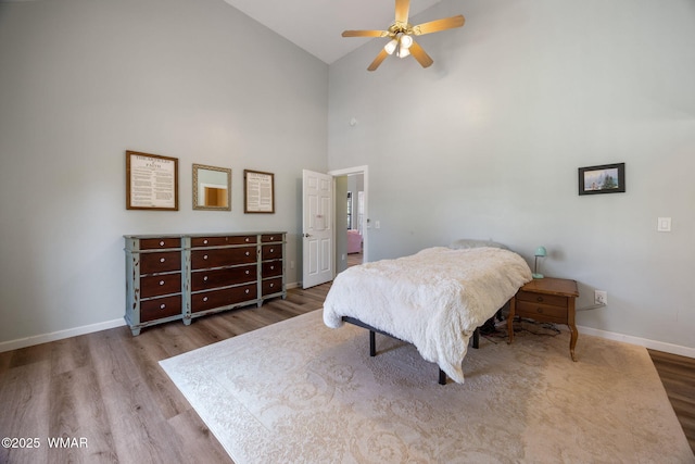 6853 Rim Rock Rd, Show Low, AZ 85901 - bedroom featuring high vaulted ceiling, wood finished floors, and a ceiling fan