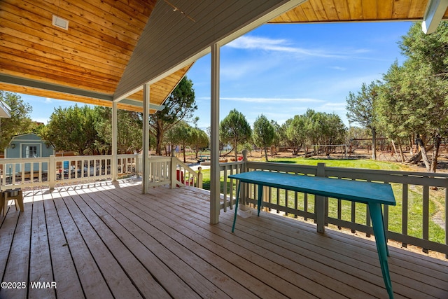 6853 Rim Rock Rd, Show Low, AZ 85901 - wooden deck featuring a storage unit