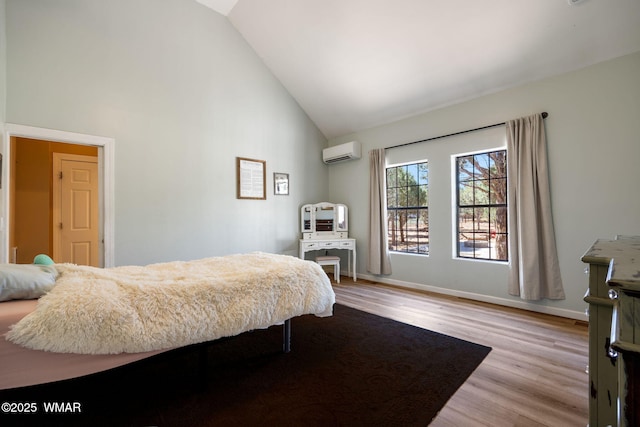 6853 Rim Rock Rd, Show Low, AZ 85901 - bedroom featuring a wall mounted AC, high vaulted ceiling, and wood finished floors