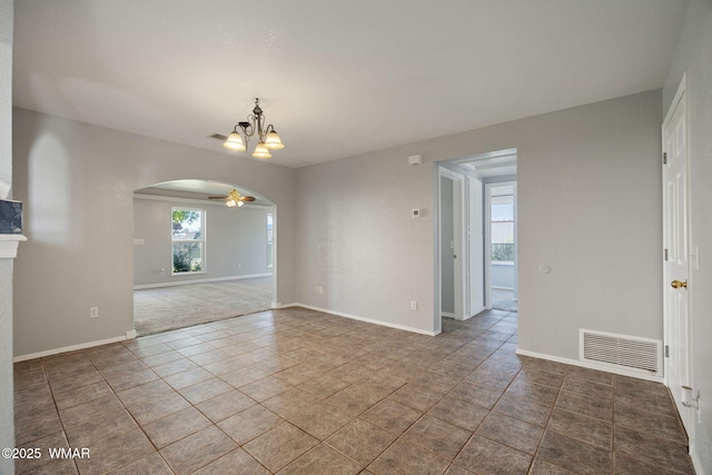864 S 1st St E, Snowflake, AZ 85937 - unfurnished room with arched walkways, a chandelier, tile patterned floors, baseboards, and a ceiling fan