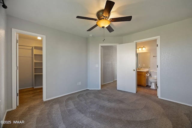 864 S 1st St E, Snowflake, AZ 85937 - unfurnished bedroom featuring a walk in closet, carpet, baseboards, ensuite bathroom, and a sink