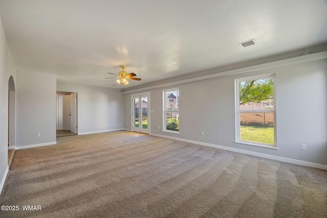 864 S 1st St E, Snowflake, AZ 85937 - empty room featuring light colored carpet, arched walkways, and ceiling fan
