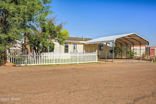 864 S 1st St E, Snowflake, AZ 85937 - view of front of property with a detached carport, a fenced front yard, and driveway