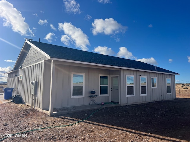 back of property featuring board and batten siding and a shingled roof