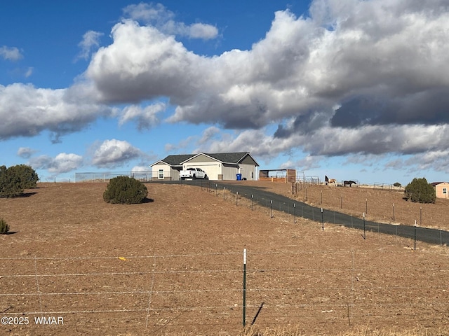 view of yard featuring a rural view and fence