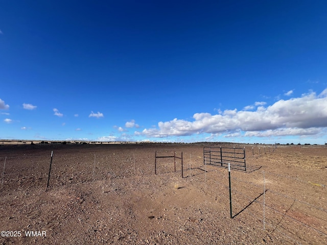 view of yard with a rural view and fence