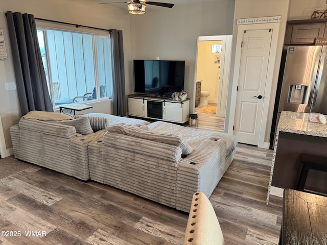 living area featuring ceiling fan and wood finished floors