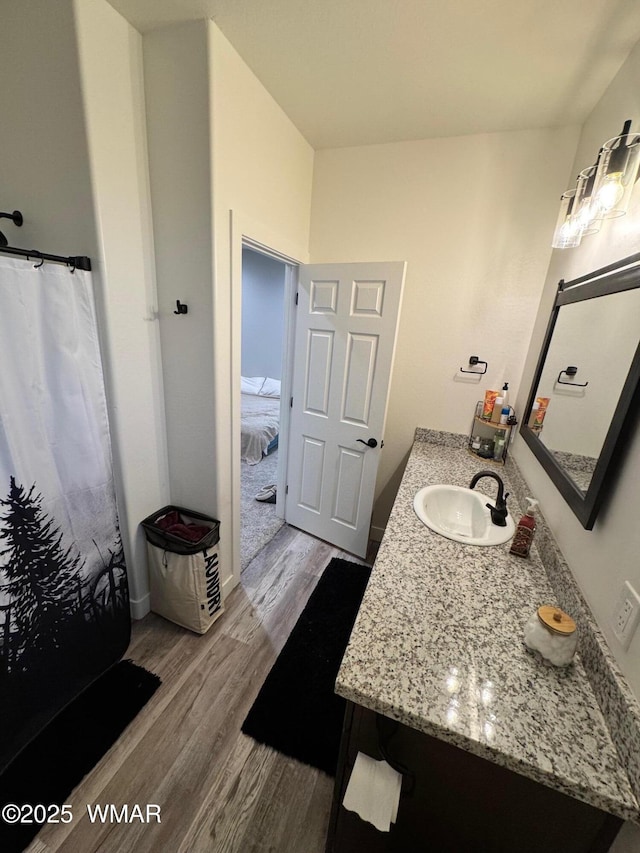 bathroom with vanity and wood finished floors