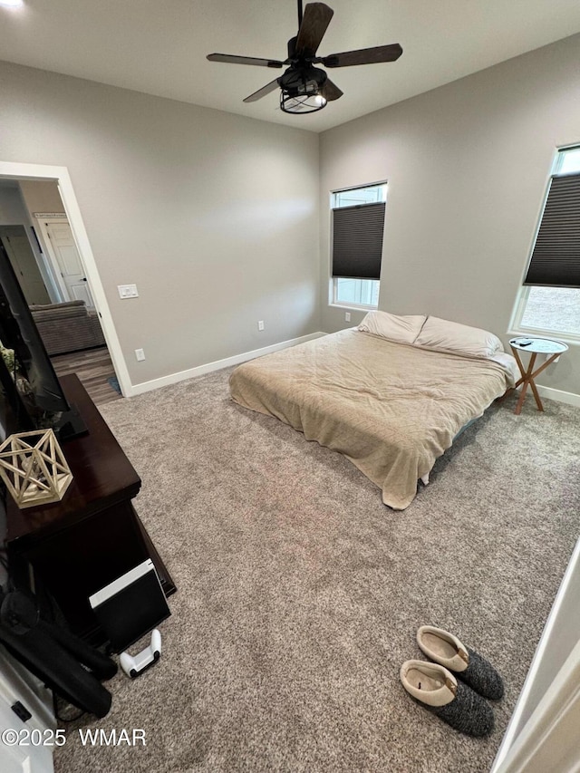 carpeted bedroom featuring baseboards and ceiling fan