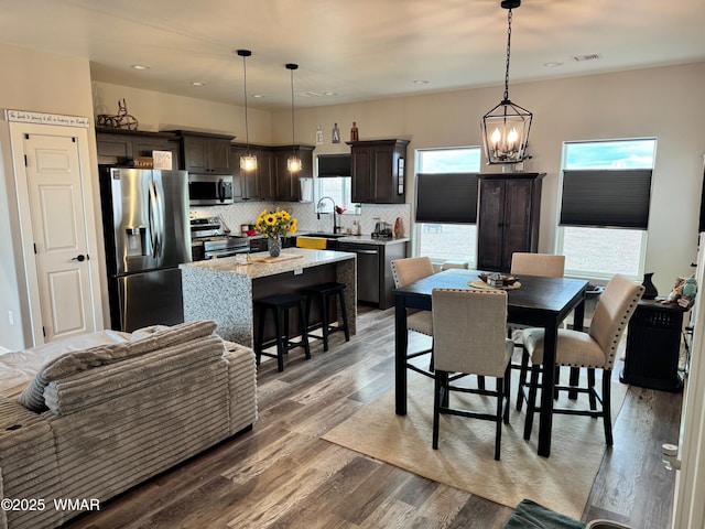 dining room featuring a notable chandelier, recessed lighting, visible vents, and light wood finished floors