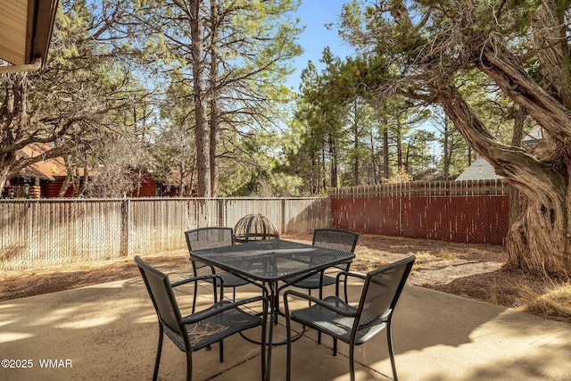 view of patio with a fenced backyard and outdoor dining area