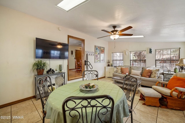 dining area featuring vaulted ceiling, light tile patterned floors, plenty of natural light, and a ceiling fan