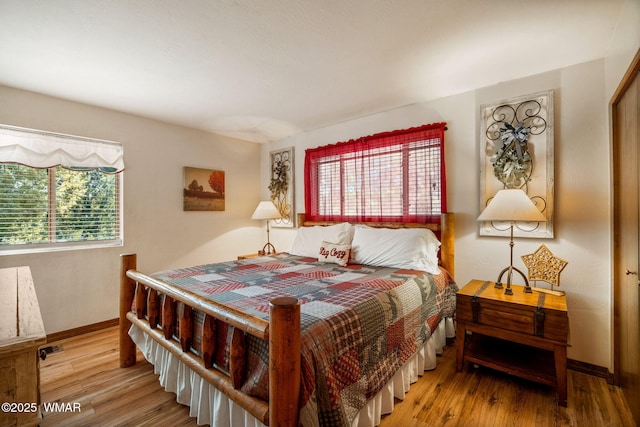 bedroom featuring wood finished floors and baseboards