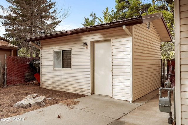 view of outbuilding featuring an outbuilding and fence