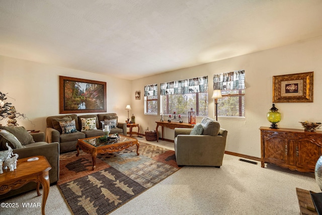 living area featuring carpet flooring, visible vents, and baseboards