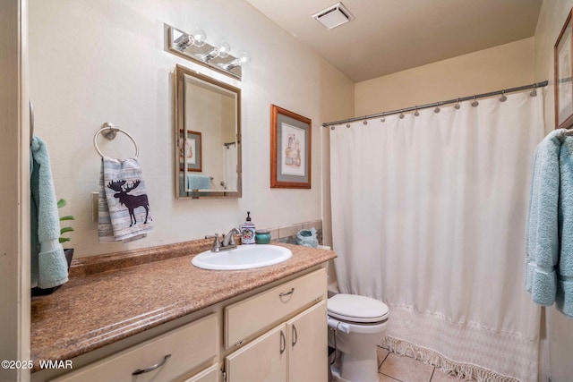 bathroom with visible vents, toilet, a shower with curtain, tile patterned flooring, and vanity