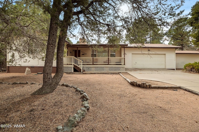 view of front facade with crawl space, driveway, a chimney, and an attached garage