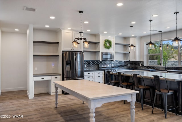1738 W 7th St, Snowflake, AZ 85937 - kitchen with open shelves, stainless steel appliances, a sink, white cabinets, and recessed lighting