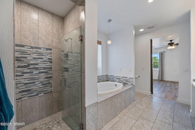 1738 W 7th St, Snowflake, AZ 85937 - bathroom featuring a garden tub, a shower stall, a ceiling fan, recessed lighting, and baseboards