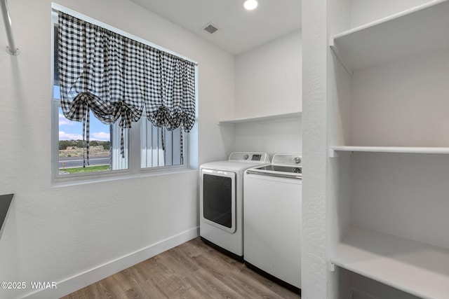 1738 W 7th St, Snowflake, AZ 85937 - washroom with washing machine and clothes dryer, light wood-style floors, and baseboards