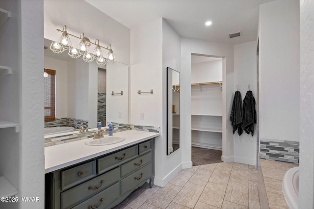 1738 W 7th St, Snowflake, AZ 85937 - full bath featuring vanity, a walk in closet, and a bathtub