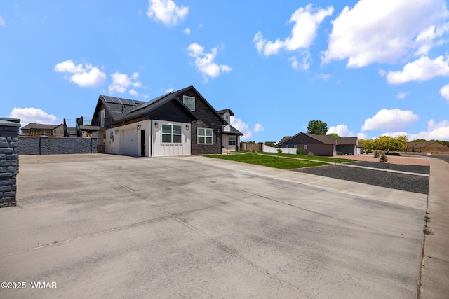 1738 W 7th St, Snowflake, AZ 85937 - view of front of property featuring solar panels, a garage, concrete driveway, and a residential view
