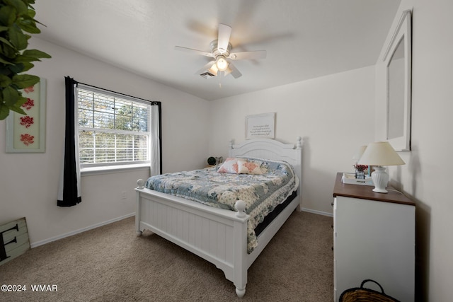 carpeted bedroom featuring visible vents, baseboards, and a ceiling fan