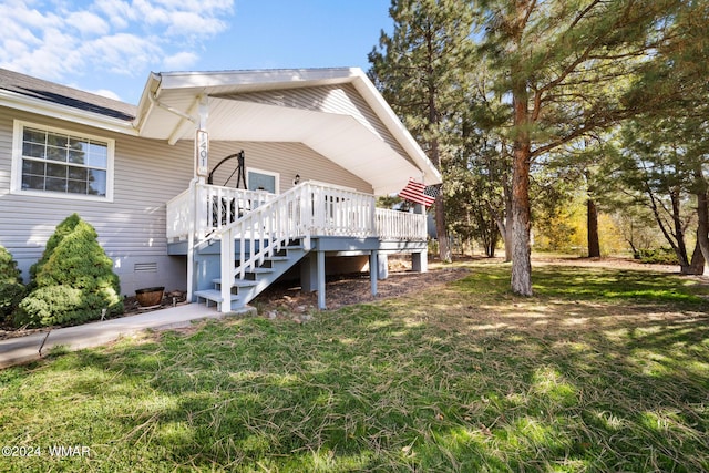 back of property featuring a deck, crawl space, a lawn, and stairway