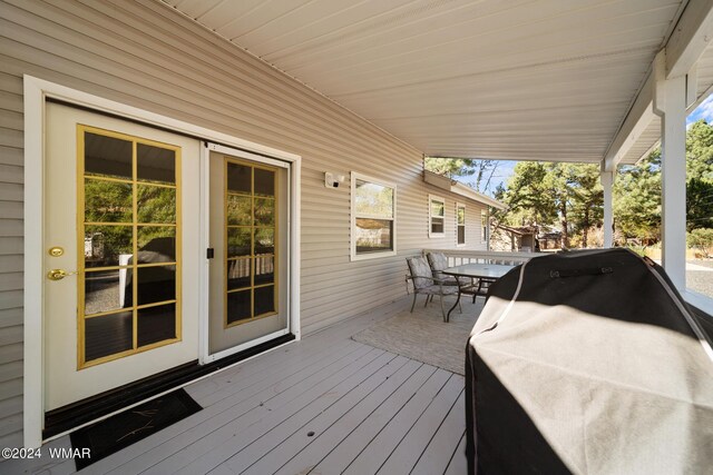 wooden deck featuring outdoor dining area and area for grilling