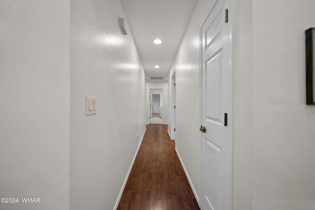 hallway with recessed lighting, wood finished floors, and baseboards