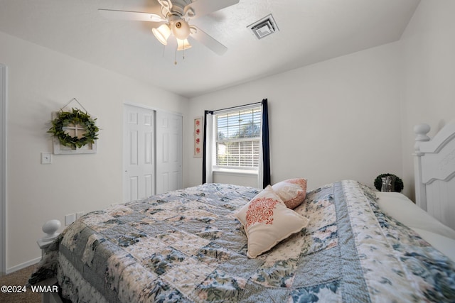 carpeted bedroom featuring baseboards, ceiling fan, visible vents, and a closet