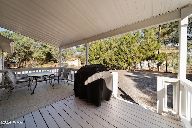 deck featuring outdoor dining area and area for grilling