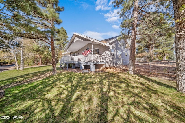 exterior space featuring a deck and a front lawn