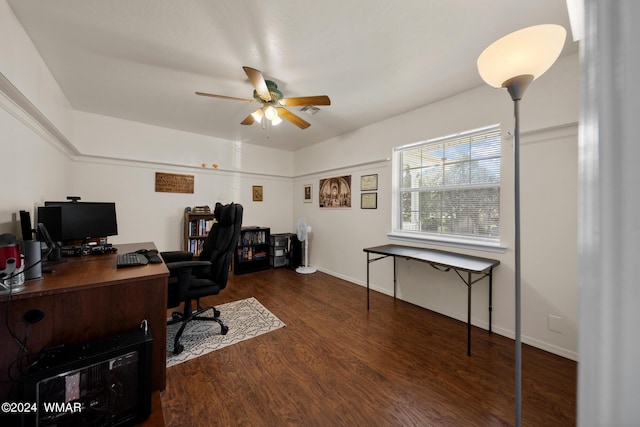 home office featuring dark wood-type flooring, baseboards, and a ceiling fan