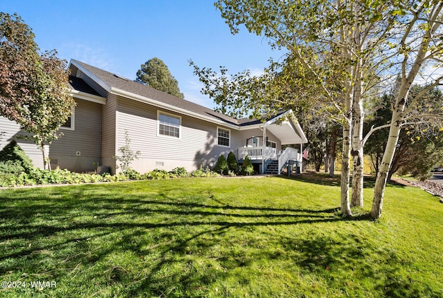 exterior space featuring crawl space, a shingled roof, stairs, and a yard