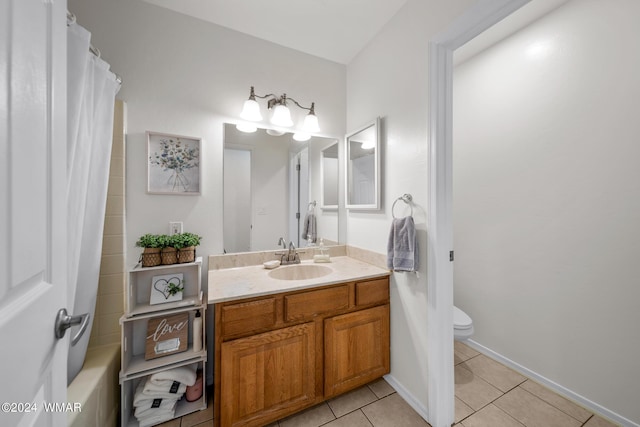 full bathroom featuring baseboards, vanity, toilet, and tile patterned floors