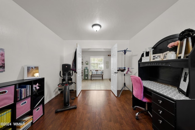 interior space with baseboards and wood finished floors