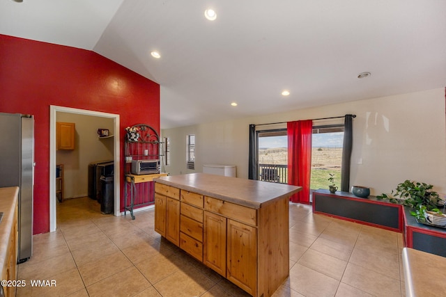 529 Foothills Blvd, Snowflake, AZ 85939 - kitchen with vaulted ceiling, freestanding refrigerator, light tile patterned flooring, a center island, and recessed lighting