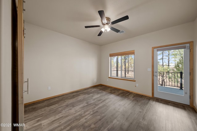 unfurnished room featuring baseboards, visible vents, ceiling fan, and wood finished floors