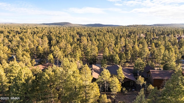 drone / aerial view featuring a forest view